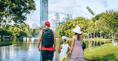 Mother and sons in Lumpini park in Bangkok city  - obrazy, fototapety, plakaty
