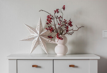 Holiday mood. Christmas decor on a white chest of drawers