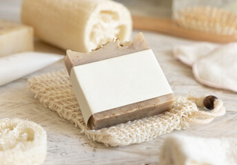 Beige handmade soap bar with blank label close up, packaging mockup - obrazy, fototapety, plakaty
