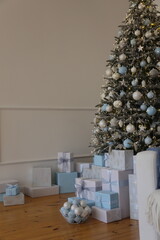 new year and Christmas tree with white and blue toys and gift boxes