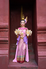 Fototapeta na wymiar Pretty Asian women wearing beautiful Thai traditional dress in Hundred Thousand Lantern Festival or Yi Peng Festival for worship at Phra That Hariphunchai temple in Lamphun, Thailand.