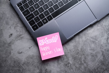 Flat lay photo of laptop with pink postit for international Women's day 8th march. Future is female. - obrazy, fototapety, plakaty