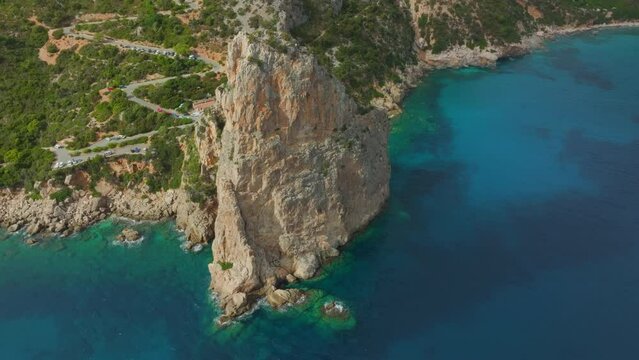 aerial view in orbit over the Monolite di Pedra Longa on the island of Sardinia on a sunny day.