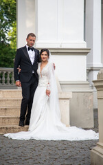 happy bride and groom posing on their wedding day