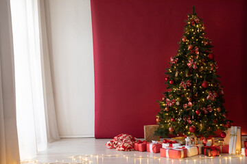Christmas tree with red gifts in the white room Christmas
