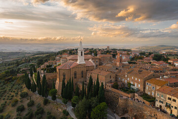 A captivating aerial view of a picturesque town in the heart of southern Tuscany, Italy. This drone-captured image showcases the charming beauty of Italian architecture, narrow streets, and a historic - 672172128