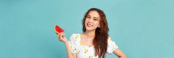 Pretty young woman with juicy watermelon on color background