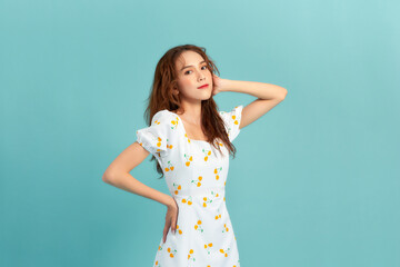 Obraz premium Portrait of young beautiful smiling female in trendy summer dress.