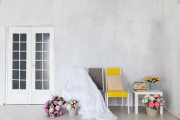 Yellow armchair and coffee table in white room interior