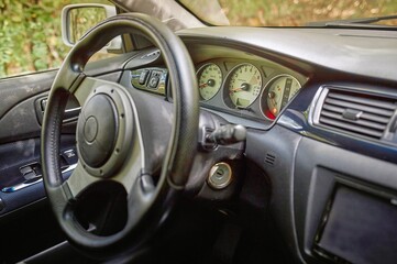 Car steering wheel and car sensors, inerior background, modern city car elements close view. Car...