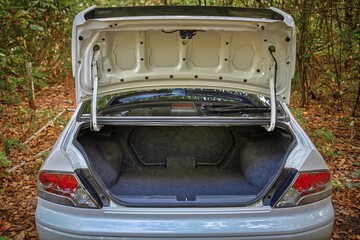 Opened car trunk, city car empty trunk