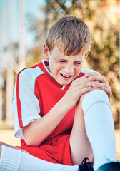 Soccer, children and knee injury with a boy hurt on a sports field during a competitive game or...