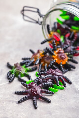 Scary sweet jelly spiders. Halloween candies on kitchen table.