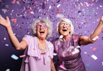 diverse happy two senior women celebrating New Year at party with confetti on pastel lilac background. Female couple. Birthday celebration.