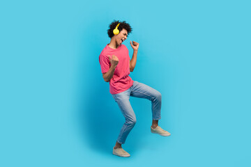 Fototapeta na wymiar Full body photo of handsome young male dancer discotheque earphones have fun dressed stylish pink outfit isolated on blue color background