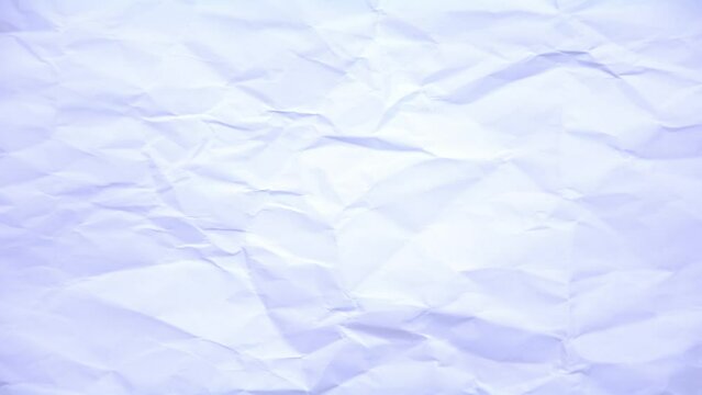 Crumpled paper background. A crumpled piece of white paper texture stop motion animation. Seamless looping.