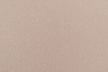 texture of beige fabric flowing close-up. material for sewing dresses, blouses. image for your...