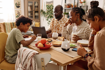 Cheerful Black family having breakfast at big table - obrazy, fototapety, plakaty