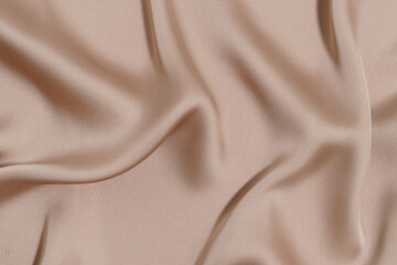 crumpled and wrinkled beige fabric texture close-up. material for sewing dresses, blouses. image for your mockup