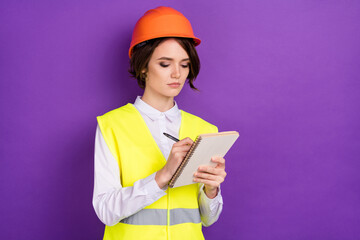 Photo of serious nice brunette hair lady write wear builder uniform isolated on purple color background