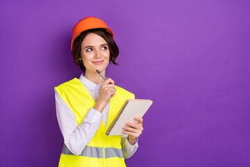 Photo of optimistic nice brunette hair lady write look empty space wear builder uniform isolated on purple color background