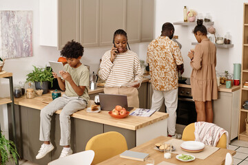 Black family spending time at home cooking, working and studying