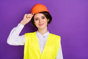Photo of optimistic nice brunette hair lady touch cap wear builder uniform isolated on vivid purple color background