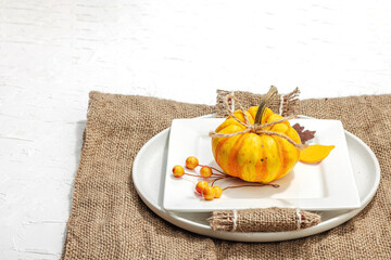 Autumn table setting. Thanksgiving cutlery, traditional fall decor. Cozy mood, minimalist design