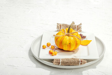 Autumn table setting. Thanksgiving cutlery, traditional fall decor. Cozy mood, minimalist design