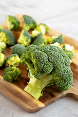 Organic Raw Broccoli Florets on a wooden board, side view. Close-up.