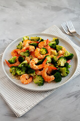 Homemade Garlic Broccoli Shrimp Stir Fry on a Plate, side view. Close-up.