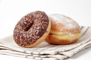 Chocolate donuts on a tablecloth