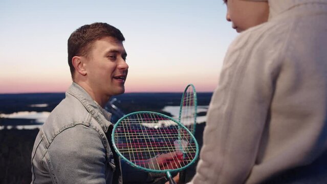 Man Conquering with son about Tennis Skills