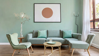 Ellipse table and two chairs near mint sofa against light green wall with art frame poster. Scandinavian, mid-century home interior design of modern living room.