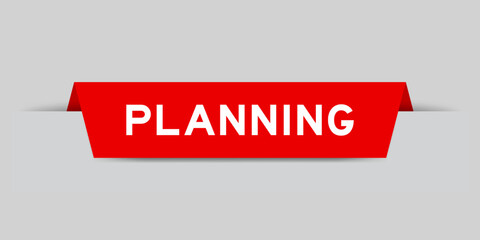 Red color inserted label with word planning on gray background