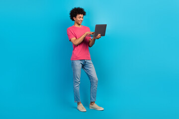 Full size photo of handsome young male hold netbook working coder manager dressed stylish pink...