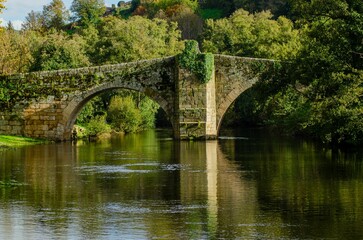 Medieval stone bridge over the Arnoia river in the town of Allariz, Ourense. Galicia, Spain