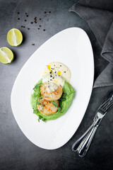  cheesecakes with creamy sauce on broccoli puree, side view