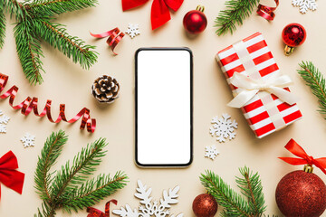 Fototapeta na wymiar Digital phone mock up with rustic Christmas decorations for app presentation top view with empty space for you design. Christmas online shopping concept. Tablet with copy space on colored background