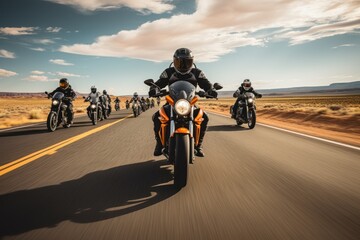 A group of motorcyclists ride motorcycles together on an empty road.