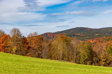 Landscape with fields and trees on the hills in autumn colors
