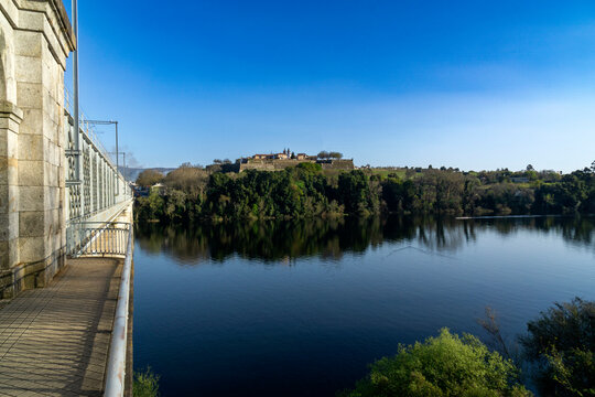 View of the Valença de Minho fortress reflecting in the river and the International Iron Bridge. Portugal.