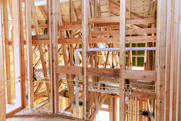 Construction new home unfinished framing beams wooden house in construction area
