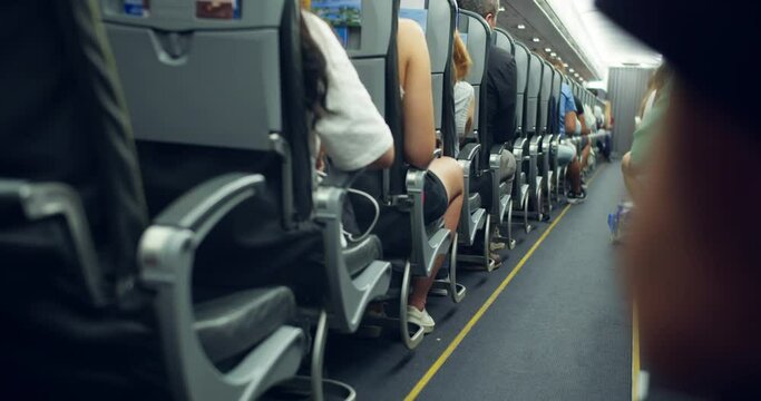 Passengers sits inside airplane during flight. People travels. Jet passenger plane interior view with unrecognizable passengers