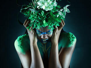 Frustrated, nature and mother earth model feeling sad from climate change in studio. Costume...
