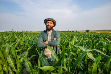 Portrait of farmer who is cultivating corn. Agricultural occupation.