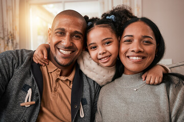 Happy, smile and portrait of a family in the living room hugging with love, care and comfort at home. Happiness, excited and girl child holding her mother and father in the lounge of their house. - obrazy, fototapety, plakaty