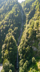 Obraz premium Tar stream cloud waterfall. Aerial view of waterfall flowing over mountain covered with forest. Natural beauties of Rize. Tourist places of Turkey. local name tar deresi bulut selalesi