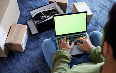 Ecommerce, man with laptop, green screen and boxes on floor, shoes and delivery service on digital app. Sale, discount and online shopping on fashion retail brand website, internet search on computer - obrazy, fototapety, plakaty