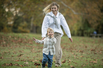 Fototapeta premium Mothers day, love family. Family on autumn walk in nature outdoors. Mother and child with hugging tenderness